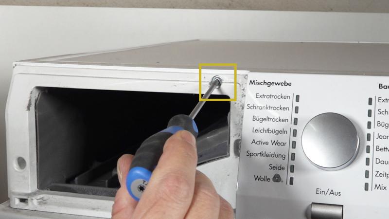 Vordere Schraube des Gerätedeckels entfernen Vordere Schraube des Gerätedeckels entfernen